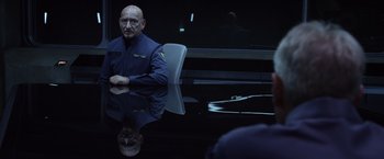 Movie still from “Ender's Game” (2013), directed by Gavin Hood – A man sitting at a table in front of a mirror; Medium shot, Over the shoulder angle