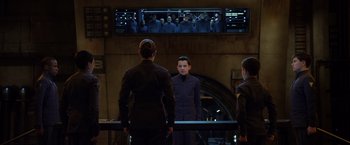 Movie still from “Ender's Game” (2013), directed by Gavin Hood – A group of people standing in front of a mirror; Medium shot, Over the shoulder angle