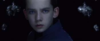 Movie still from “Ender's Game” (2013), directed by Gavin Hood – A young boy with blue eyes stares into the camera; Close Up shot, High angle