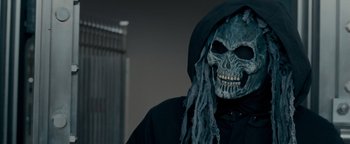 Movie still from “The Town” (2010), directed by Ben Affleck – A person wearing a skull mask and a black jacket; Close Up shot, Low angle