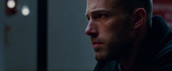 Movie still from “The Town” (2010), directed by Ben Affleck – A man's face in a dark room; Close Up shot, Low angle