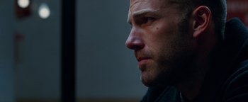 Movie still from “The Town” (2010), directed by Ben Affleck – A man's face in a dark room; Close Up shot, Over the shoulder angle
