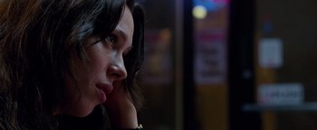 Movie still from “The Town” (2010), directed by Ben Affleck – A person sitting down with her hand to her ear; Close Up shot, Low angle