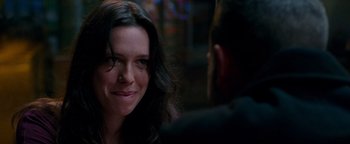 Movie still from “The Town” (2010), directed by Ben Affleck – A person smiling at the camera; Close Up shot, Over the shoulder angle