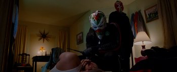 Movie still from “The Town” (2010), directed by Ben Affleck – A man in a wrestling mask is holding a knife; Medium shot, Low angle