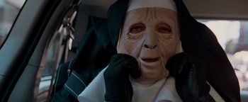 Movie still from “The Town” (2010), directed by Ben Affleck – An old woman dressed up as a nun with gloves on; Close Up shot, High angle