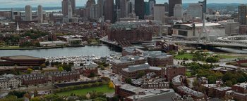 Movie still from “The Town” (2010), directed by Ben Affleck – An aerial view of a city with boats in the water; Extreme Wide shot, High angle