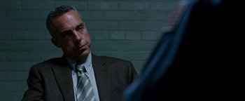 Movie still from “The Town” (2010), directed by Ben Affleck – A man wearing a suit and tie looking at a mirror; Close Up shot, Over the shoulder angle