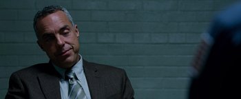 Movie still from “The Town” (2010), directed by Ben Affleck – A person wearing a suit and tie; Close Up shot, Over the shoulder angle