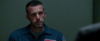 Movie still from “The Town” (2010), directed by Ben Affleck – A person wearing a uniform; Close Up shot, Low angle