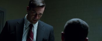 Movie still from “The Town” (2010), directed by Ben Affleck – A man wearing a suit and tie in front of another man; Close Up shot, Over the shoulder angle