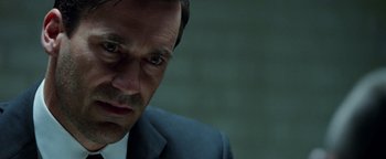 Movie still from “The Town” (2010), directed by Ben Affleck – A person wearing a suit and tie; Close Up shot, Over the shoulder angle