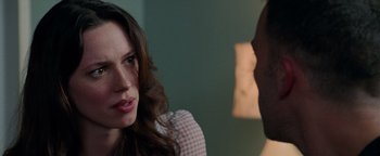 Movie still from “The Town” (2010), directed by Ben Affleck – A woman sitting next to a man in a room; Close Up shot, Over the shoulder angle