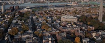 Movie still from “The Town” (2010), directed by Ben Affleck – An aerial view of a city with many buildings and trees; Extreme Wide shot, High angle