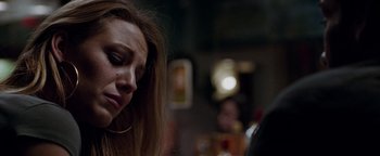 Movie still from “The Town” (2010), directed by Ben Affleck – A person sitting at a table; Close Up shot, Low angle