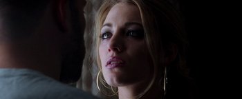 Movie still from “The Town” (2010), directed by Ben Affleck – A person wearing a pair of earrings; Close Up shot, Over the shoulder angle