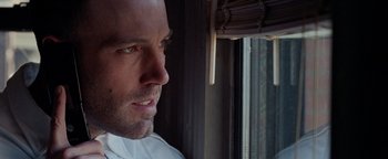 Movie still from “The Town” (2010), directed by Ben Affleck – A person looking out of a window; Close Up shot, Low angle