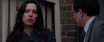 Movie still from “The Town” (2010), directed by Ben Affleck – A woman standing in front of a brick wall; Close Up shot, Over the shoulder angle
