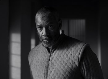 Movie still from “The Tragedy of Macbeth” (2021), directed by Joel Coen – Black and white photograph of a man wearing a quilted jacket; Close Up shot, Low angle