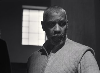 Movie still from “The Tragedy of Macbeth” (2021), directed by Joel Coen – A black and white photo of a man with a goatee; Medium shot, Low angle