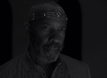 Movie still from “The Tragedy of Macbeth” (2021), directed by Joel Coen – A black and white photo of a man with a beard; Close Up shot, Low angle
