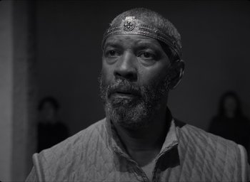 Movie still from “The Tragedy of Macbeth” (2021), directed by Joel Coen – A black and white photo of a man with a beard; Close Up shot, Low angle