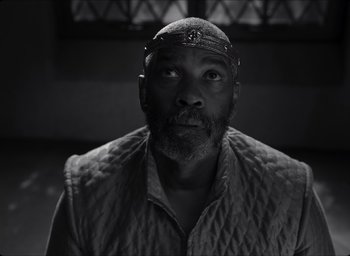 Movie still from “The Tragedy of Macbeth” (2021), directed by Joel Coen – A black and white photo of a man with a beard; Close Up shot, Low angle