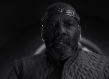 Movie still from “The Tragedy of Macbeth” (2021), directed by Joel Coen – A black and white photo of a man with a beard; Close Up shot, Low angle