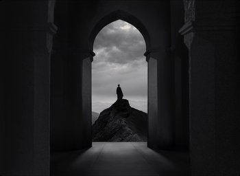 Movie still from “The Tragedy of Macbeth” (2021), directed by Joel Coen – A man standing on a mountain looking out through an archway; Extreme Wide shot, Low angle
