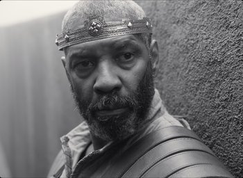 Movie still from “The Tragedy of Macbeth” (2021), directed by Joel Coen – Black and white photograph of a man with a beard wearing a crown; Close Up shot, Low angle