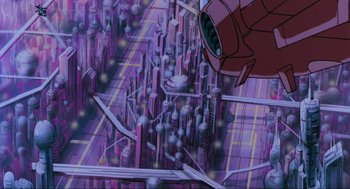 Movie still from “The Transformers: The Movie” (1986), directed by Nelson Shin – An image of an animated city in the middle of the night; Extreme Wide shot, Overhead angle