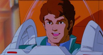 Movie still from “The Transformers: The Movie” (1986), directed by Nelson Shin – A cartoon of a man in a car; Close Up shot, Low angle