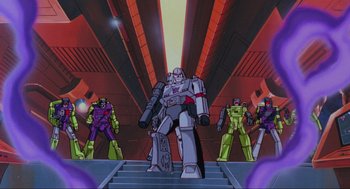 Movie still from “The Transformers: The Movie” (1986), directed by Nelson Shin – A group of people standing next to each other in a room; Extreme Wide shot, Low angle