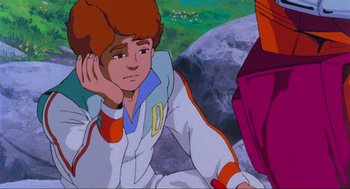 Movie still from “The Transformers: The Movie” (1986), directed by Nelson Shin – A young man sitting on the ground in front of the moon; Medium shot, High angle