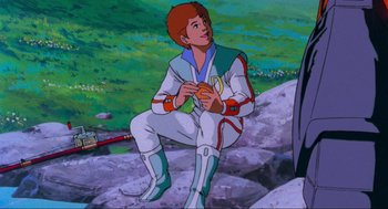 Movie still from “The Transformers: The Movie” (1986), directed by Nelson Shin – A man sitting on the ground holding a frisbee; Medium shot, Over the shoulder angle