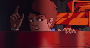 Movie still from “The Transformers: The Movie” (1986), directed by Nelson Shin – A cartoon of a boy looking at something in his hand; Close Up shot, High angle