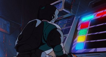 Movie still from “The Transformers: The Movie” (1986), directed by Nelson Shin – An animation of a man playing a video game; Medium shot, Low angle