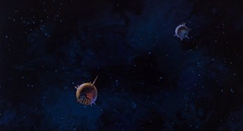 Movie still from “The Transformers: The Movie” (1986), directed by Nelson Shin – A group of sea urchins floating in the ocean; Extreme Wide shot, Overhead angle