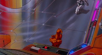 Movie still from “The Transformers: The Movie” (1986), directed by Nelson Shin – A computer screen with a computer keyboard and mouse on top of it; Extreme Wide shot, High angle