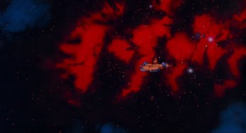 Movie still from “The Transformers: The Movie” (1986), directed by Nelson Shin – An image of a space ship flying through the night sky; Extreme Wide shot, Overhead angle