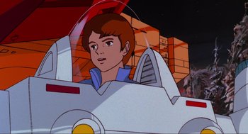 Movie still from “The Transformers: The Movie” (1986), directed by Nelson Shin – A cartoon of a boy in the back of a white car; Medium shot, Low angle