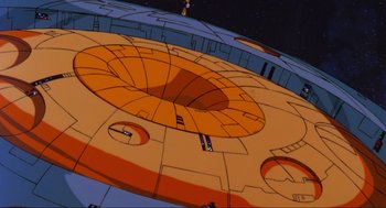 Movie still from “The Transformers: The Movie” (1986), directed by Nelson Shin – View of a space ship from below; Extreme Wide shot, Overhead angle
