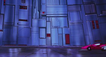 Movie still from “The Transformers: The Movie” (1986), directed by Nelson Shin – A painting of a blue building with red windows and doors; Extreme Wide shot, Low angle