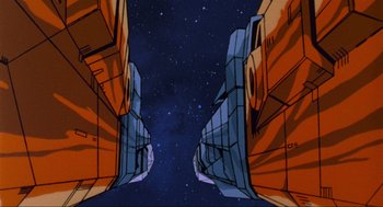 Movie still from “The Transformers: The Movie” (1986), directed by Nelson Shin – An image of an animated space ship looking up at the sky; Extreme Wide shot, Low angle