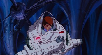 Movie still from “The Transformers: The Movie” (1986), directed by Nelson Shin – A boy is sitting in a space ship in a cartoon; Wide shot, Low angle