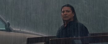 Movie still from “The Twilight Saga: Breaking Dawn - Part 1” (2011), directed by Bill Condon – A man standing in front of a window in the rain; Close Up shot, Low angle