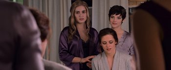 Movie still from “The Twilight Saga: Breaking Dawn - Part 1” (2011), directed by Bill Condon – A group of women standing next to each other in front of a mirror; Medium shot, Over the shoulder angle
