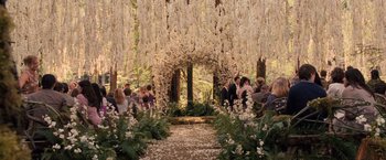 Movie still from “The Twilight Saga: Breaking Dawn - Part 1” (2011), directed by Bill Condon – A group of people standing under a floral arch; Wide shot, High angle