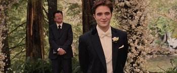 Movie still from “The Twilight Saga: Breaking Dawn - Part 1” (2011), directed by Bill Condon – A man in a tuxedo standing next to another man in a suit; Medium shot, Over the shoulder angle