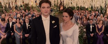 Movie still from “The Twilight Saga: Breaking Dawn - Part 1” (2011), directed by Bill Condon – A man and a woman standing next to each other in front of a crowd of onlookers; Medium shot, Over the shoulder angle